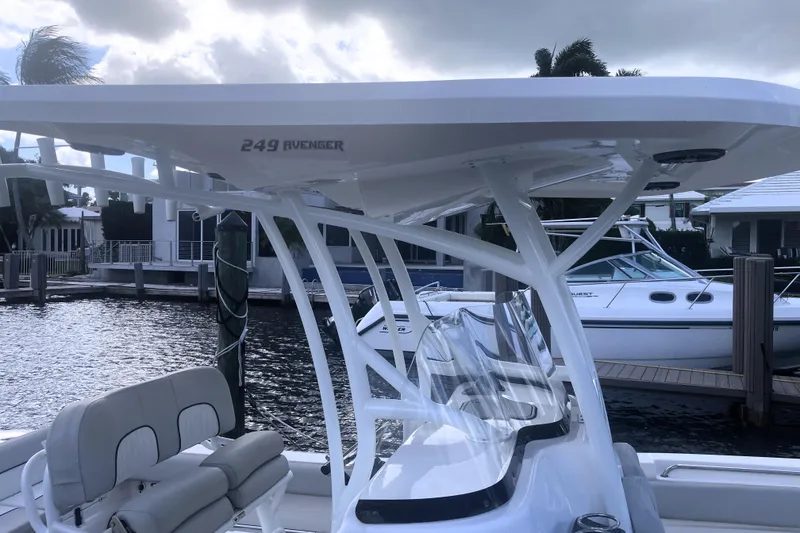 Slide: The Image of 2021 Sea Fox 249 Avenger boat docked at marina, featuring sleek design and seating. - 49