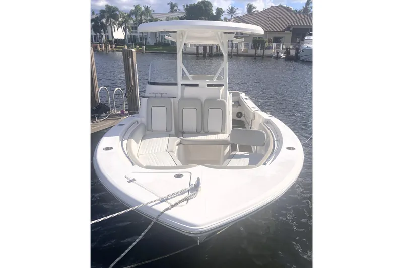 Slide: The Image of 2021 Sea Fox 249 Avenger boat docked on a sunny waterfront. - 6