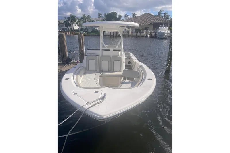 Slide: The Image of 2021 Sea Fox 249 Avenger boat docked on a sunny waterfront. - 7