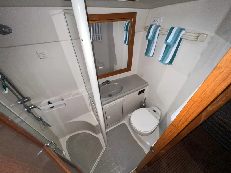 Slide: The Image of Bathroom in 2001 Riviera Twin Cabin Convertible with shower and toilet. - 11