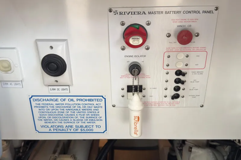 Slide: The Image of Control panel of a 2001 Riviera Twin Cabin Convertible boat with oil discharge warning. - 21