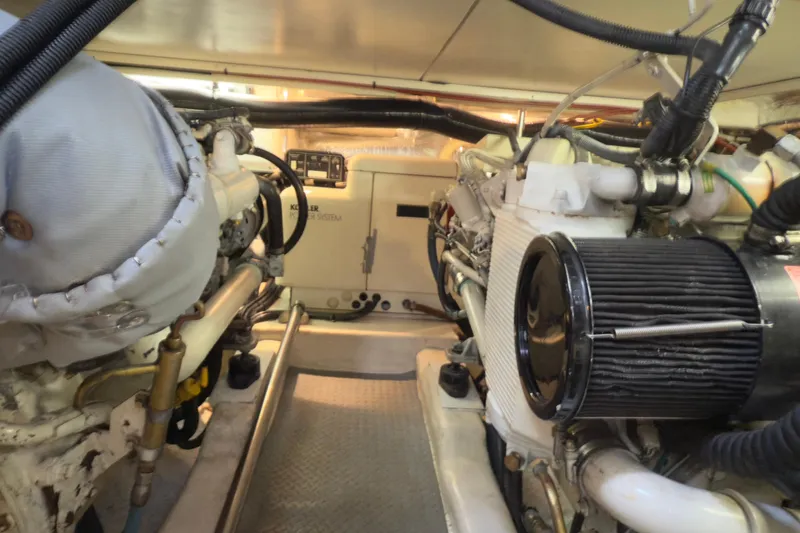 Slide: The Image of Engine room of a 2001 Riviera Twin Cabin Convertible yacht, showcasing mechanical components. - 22