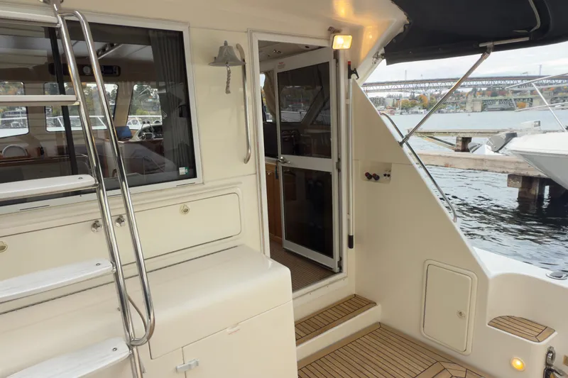 Slide: The Image of 2001 Riviera Twin Cabin Convertible yacht interior with open door and dock view. - 24