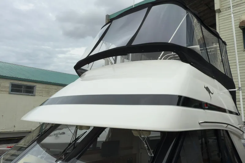 Slide: The Image of 2001 Riviera Twin Cabin Convertible yacht with sleek design and enclosed flybridge. - 30