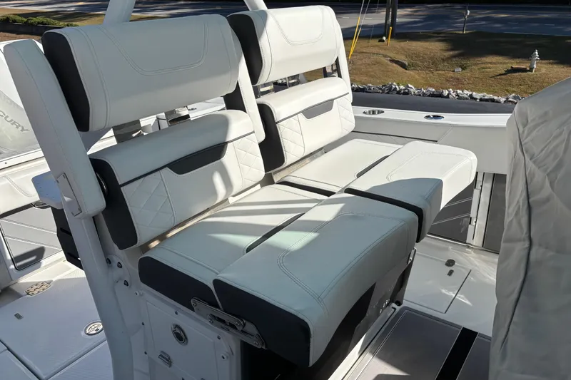 Slide: The Image of 2023 Blackfin 272CC boat interior with white cushioned seating and modern design. - 15