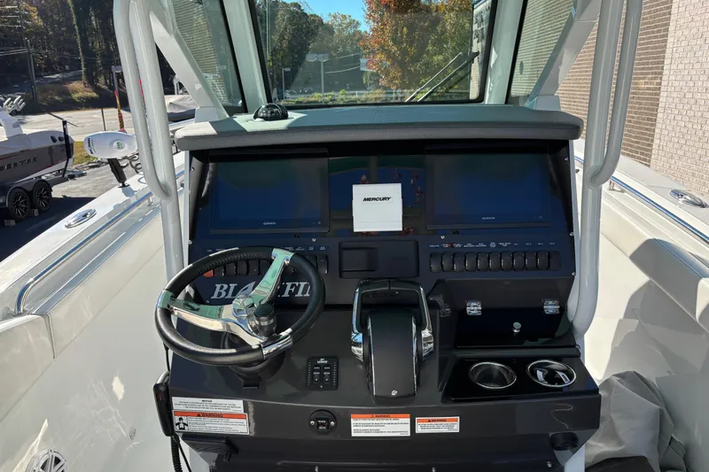Slide: The Image of 2023 Blackfin 272CC boat dashboard with steering wheel and control panel. - 16