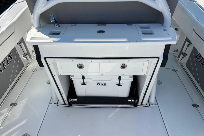 Slide: The Image of 2023 Blackfin 272CC boat interior with Yeti cooler and storage compartment. - 8