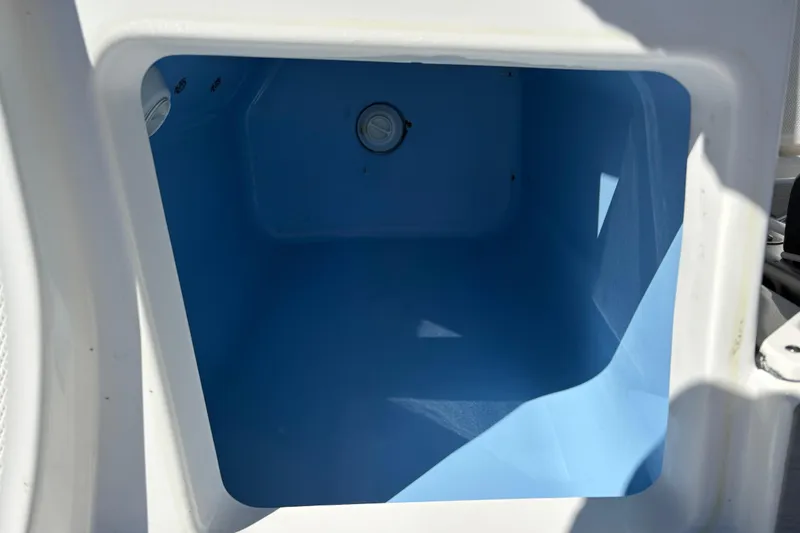 Slide: The Image of 2023 Blackfin 272CC boat storage compartment, featuring a spacious, light blue interior. - 9