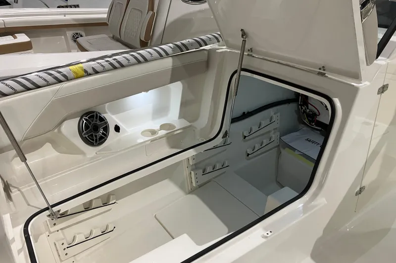 Slide: The Image of 2026 World Cat 265 DC-X boat interior with open storage compartment and seating. - 33