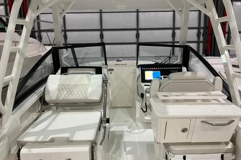 Slide: The Image of 2026 World Cat 265 DC-X boat interior with modern seating and navigation console. - 16