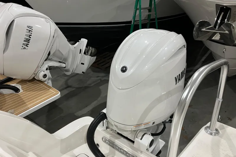 Slide: The Image of 2026 World Cat 265 DC-X with Yamaha outboard engines, showcased in a boat showroom. - 15