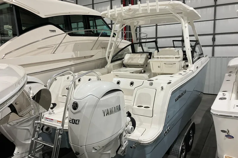 Slide: The Image of 2026 World Cat 265 DC-X boat with Yamaha engine in showroom. - 11