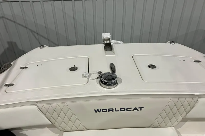 Slide: The Image of 2026 World Cat 265 DC-X boat deck with storage compartments and sleek design. - 32