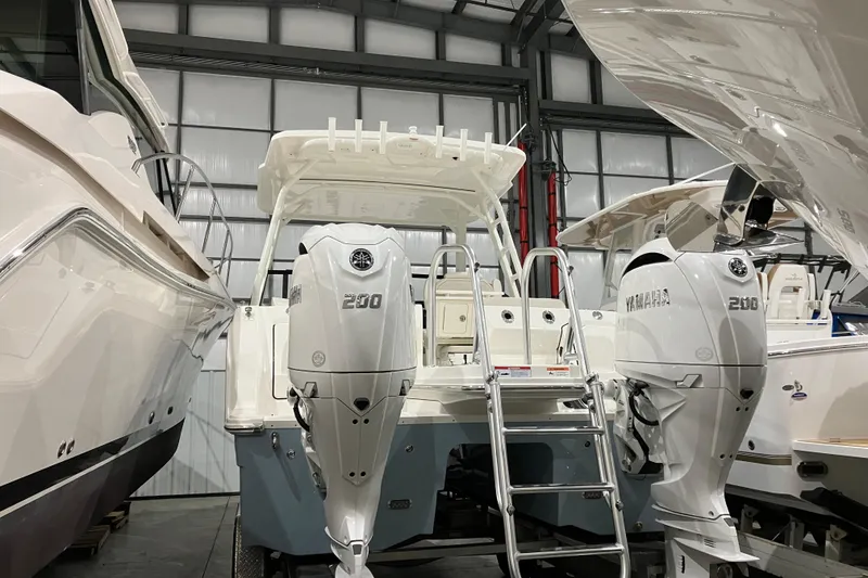 Slide: The Image of 2026 World Cat 265 DC-X boat with twin Yamaha 200 engines in a showroom. - 8