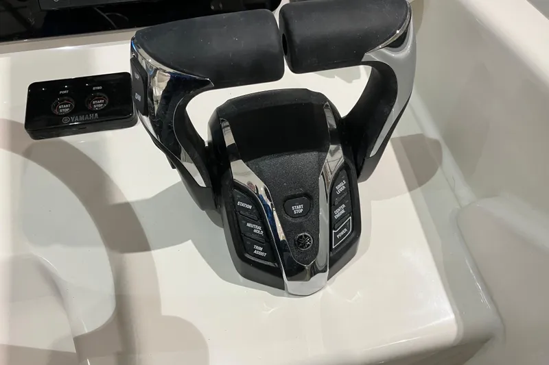 Slide: The Image of Throttle controls on a 2026 World Cat 265 DC-X boat, featuring Yamaha start-stop buttons. - 27