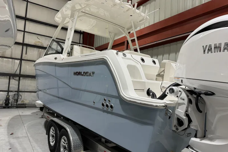 Slide: The Image of 2026 World Cat 265 DC-X boat in a warehouse, featuring Yamaha outboard motor. - 3