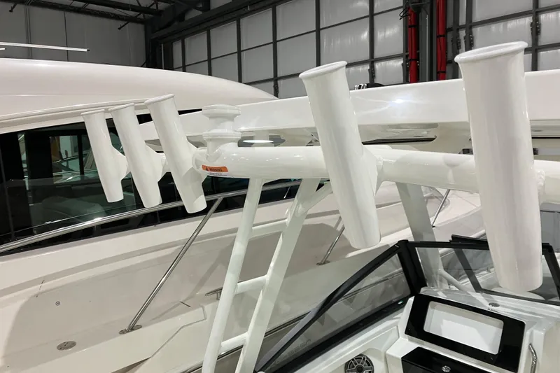 Slide: The Image of 2026 World Cat 265 DC-X boat with rod holders in a showroom. - 12