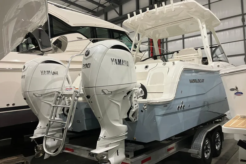 Slide: The Image of 2026 World Cat 265 DC-X boat with dual Yamaha engines in a showroom. - 7