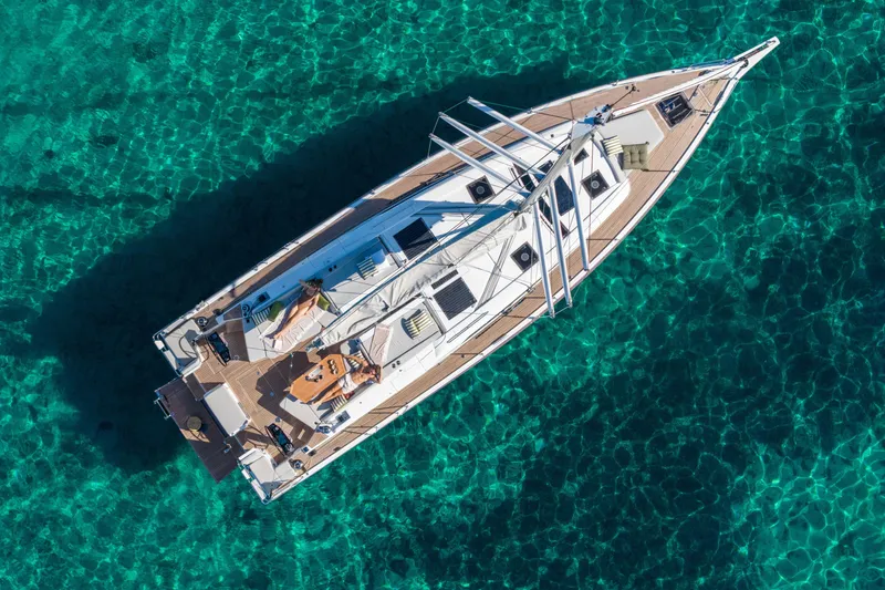 The Image of Aerial view of 2026 Beneteau Oceanis 52 yacht on clear turquoise water. - 0