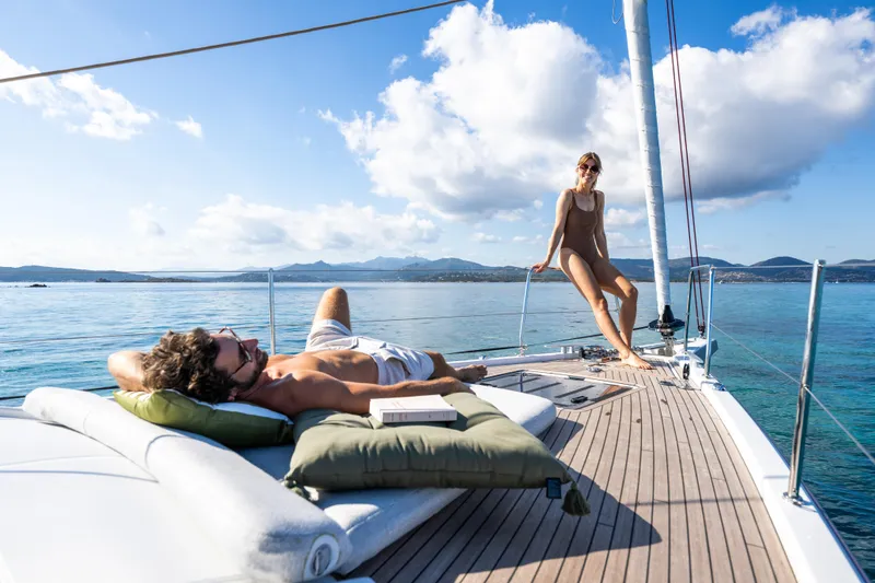 Slide: The Image of Couple relaxing on 2026 Beneteau Oceanis 52 yacht, enjoying sunny day at sea. - 15