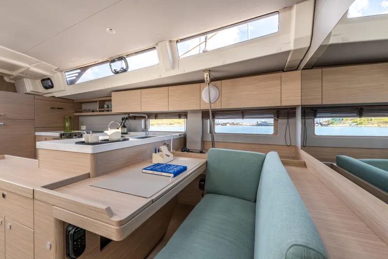 Slide: The Image of Luxurious interior of 2026 Beneteau Oceanis 52 yacht with modern kitchen and seating area. - 7