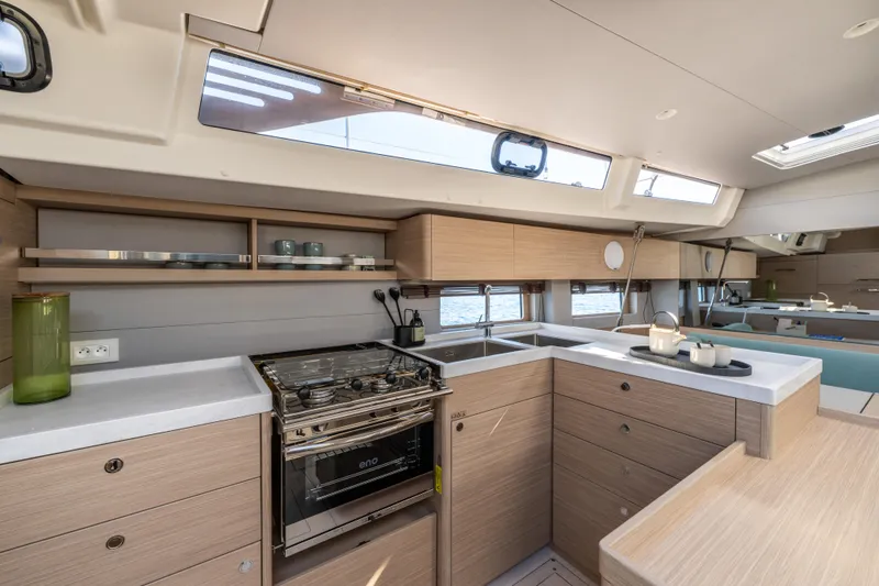 Slide: The Image of Modern kitchen interior of 2026 Beneteau Oceanis 52 yacht, featuring sleek cabinetry and appliances. - 8