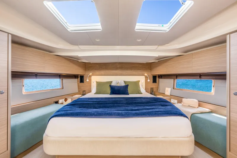 Slide: The Image of Luxurious interior of 2026 Beneteau Oceanis 52 yacht with elegant bedding and ocean view. - 9