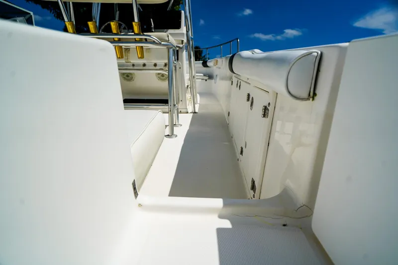 Slide: The Image of 1999 Century 2600 CC boat deck with storage compartments under clear blue sky. - 10