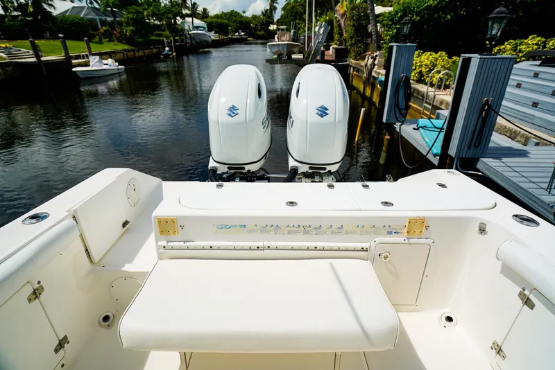 Slide: The Image of Century 2600 CC 1999 boat with dual outboard engines docked by a canal. - 5