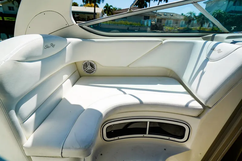 Slide: The Image of 2007 Sea Ray 280 Sundancer interior with white seating and speaker, sunny day. - 13