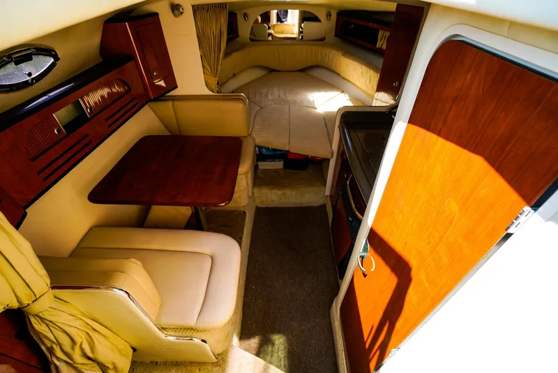 Slide: The Image of Interior of 2007 Sea Ray 280 Sundancer, featuring cozy seating and a compact dining area. - 18