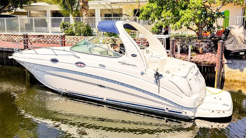 Slide: The Image of 2007 Sea Ray 280 Sundancer boat docked in a sunny waterfront setting. - 2