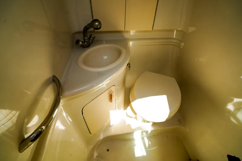 Slide: The Image of Compact bathroom in 2007 Sea Ray 280 Sundancer boat with sink and toilet. - 24