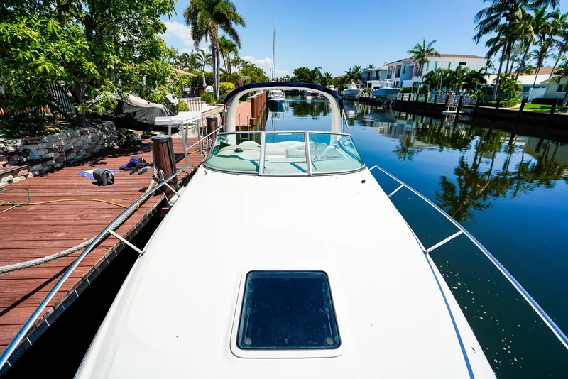 Slide: The Image of 2007 Sea Ray 280 Sundancer docked by a scenic canal with palm trees. - 30