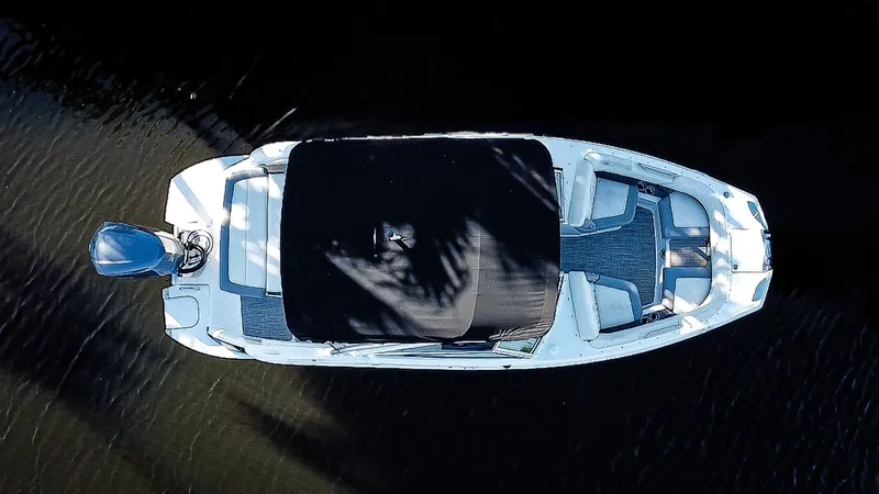 Slide: The Image of Aerial view of 2019 Cobalt 23SC boat with covered seating area on water. - 3
