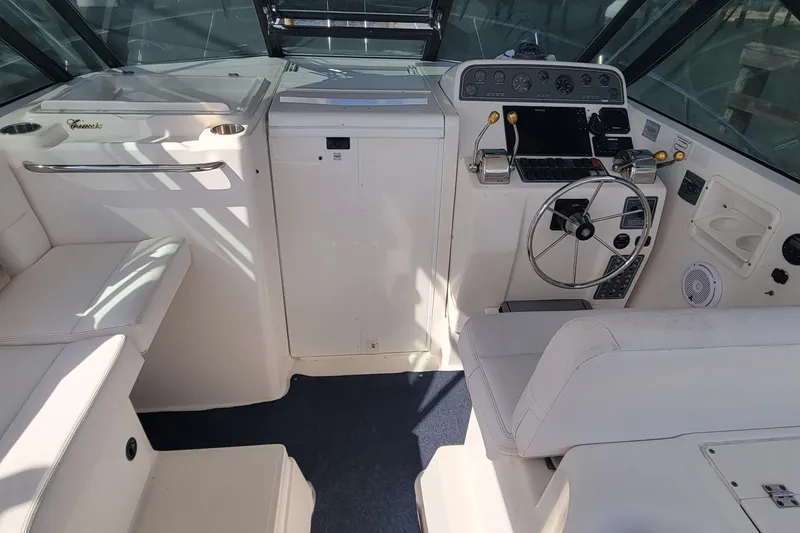 Slide: The Image of 2006 Tiara Yachts 2900 Open Classic helm with steering wheel and control panel. - 10