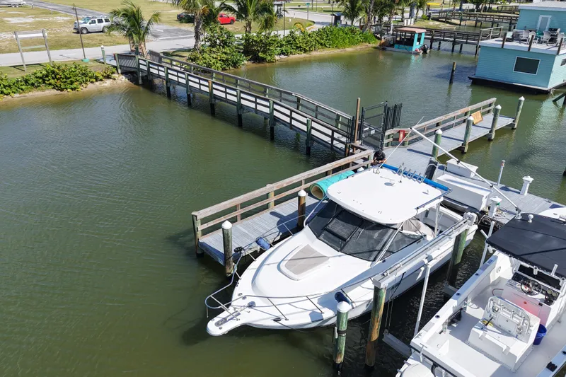 Slide: The Image of 2006 Tiara Yachts 2900 Open Classic docked at marina with wooden pier. - 20