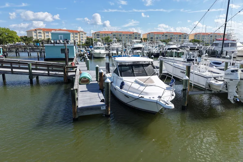 Slide: The Image of 2006 Tiara Yachts 2900 Open Classic docked at a marina with clear skies. - 21