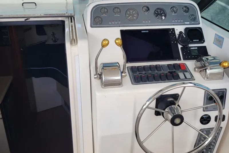 Slide: The Image of 2006 Tiara Yachts 2900 Open Classic helm with controls and navigation equipment. - 25