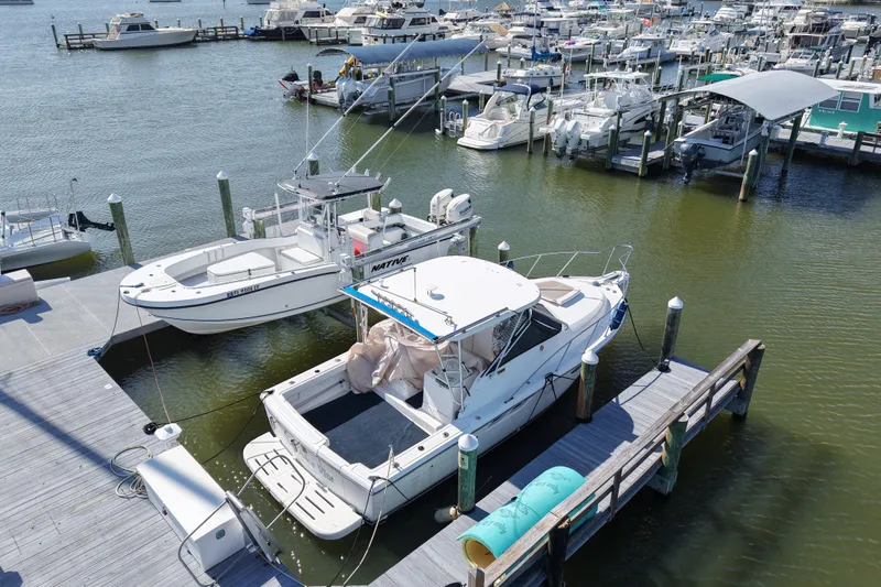 Slide: The Image of 2006 Tiara Yachts 2900 Open Classic docked at a marina with other boats. - 3
