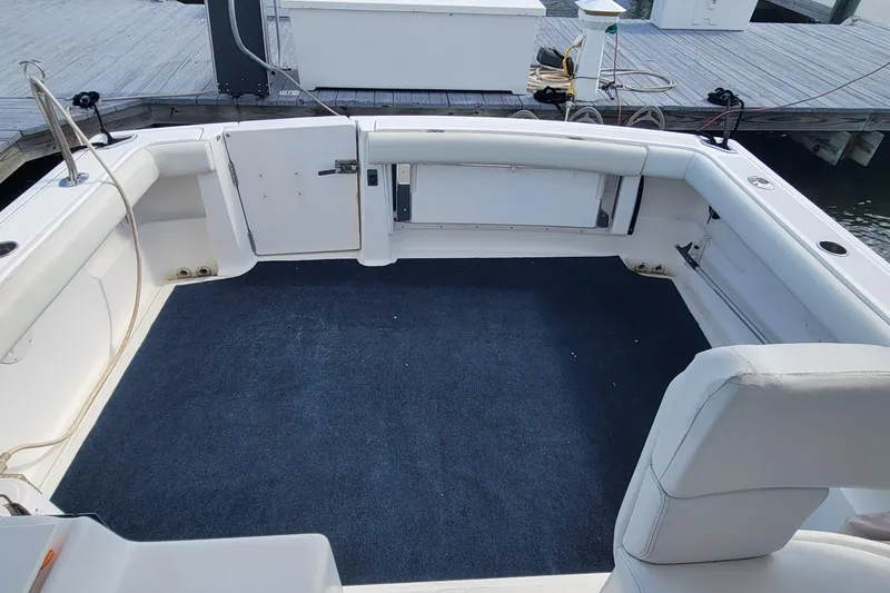 Slide: The Image of 2006 Tiara Yachts 2900 Open Classic boat interior with spacious seating and carpeted deck. - 6