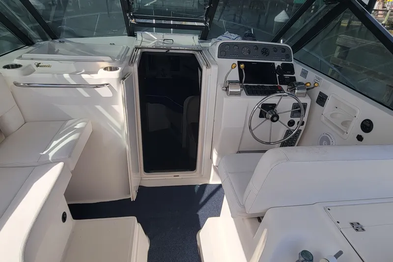 Slide: The Image of 2006 Tiara Yachts 2900 Open Classic cockpit with steering wheel and seating. - 8