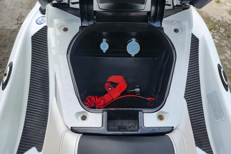 Slide: The Image of Open storage compartment of 2022 Yamaha WaveRunner VX Cruiser with red safety lanyard. - 8