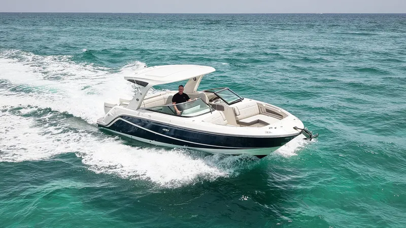 Slide: The Image of 2022 Sea Ray SLX 310 Outboard cruising on open water. - 2