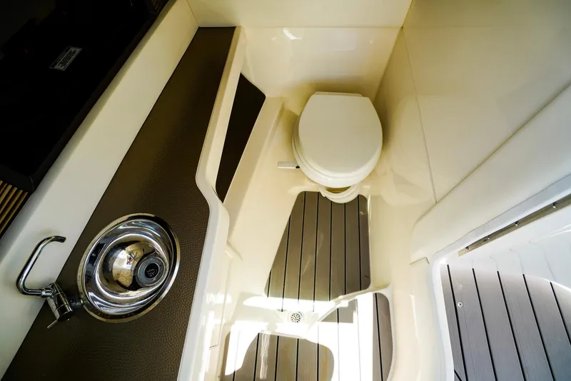 Slide: The Image of 2022 Sea Ray SLX 310 OB boat interior with toilet and sink. - 20