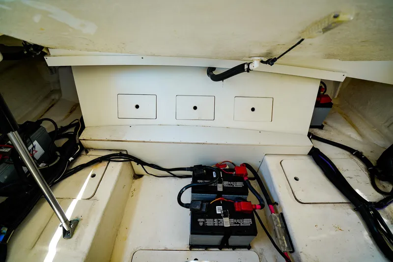 Slide: The Image of Battery compartment of 2022 Sea Ray SLX 310 OB boat, showing wiring and connections. - 27