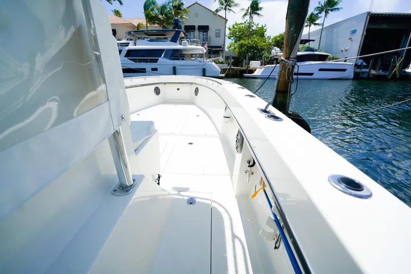 Slide: The Image of 2001 Whitewater 28 Open boat docked, featuring spacious deck and sleek design. - 12