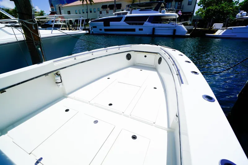 Slide: The Image of 2001 Whitewater 28 Open boat interior, docked with other yachts in the background. - 13