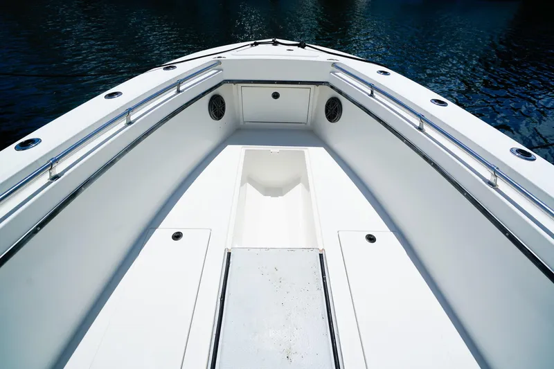 Slide: The Image of 2001 Whitewater 28 Open boat interior with sleek white deck and stainless steel railings. - 20