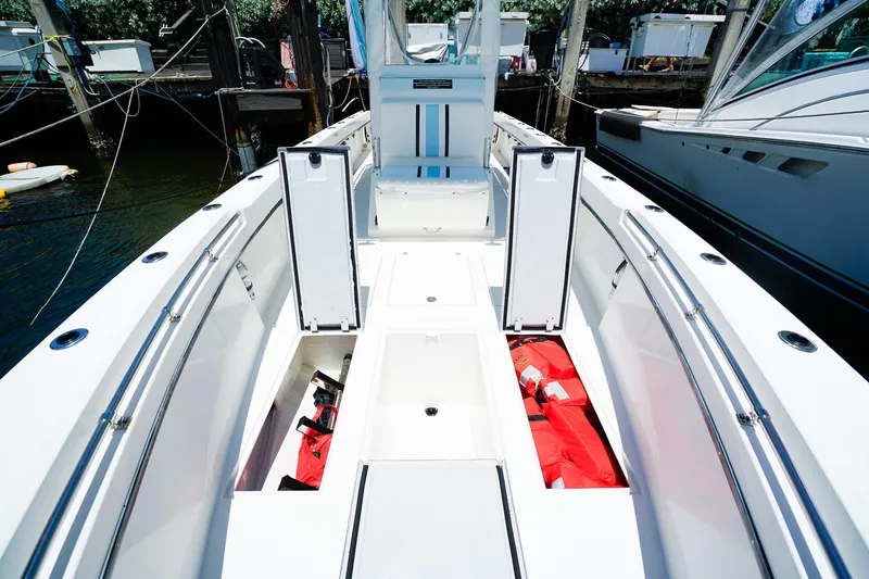 Slide: The Image of 2001 Whitewater 28 Open boat interior with storage compartments and safety gear. - 21